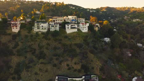 Luxury-Living-in-Hollywood-Hills,-Drone-Footage-of-Upscale-Homes-Nestled-in-Mountains-in-Los-Angeles-at-Sunset