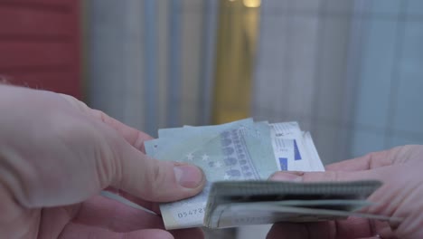 POV-close-up-of-man-counting-5-euros-bills-with-hairy-hands-and-dirty-nails