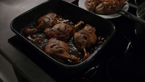 Sizzling-roasted-duck-leg-fresh-out-of-the-oven,-healthy-fat,-oily-food,-delicious-lunch,-dinner,-cooking-at-home,-grilled-fried-meat,-high-calorie-food,-cooking,-traditional-European-Christmas-dish