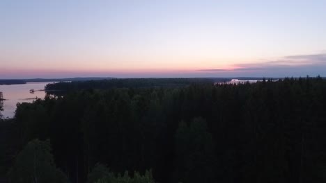 Aerial-of-a-lake-and-forest-at-dawn-in-Finland