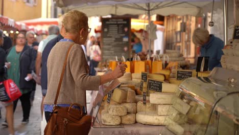 French-Lady-Buys-Cheese-from-farmer-in-Old-Town-Market-of-Annecy