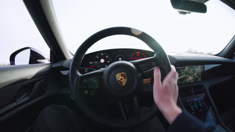 The-interior-behind-the-steering-wheel-of-a-Porsche-taycan