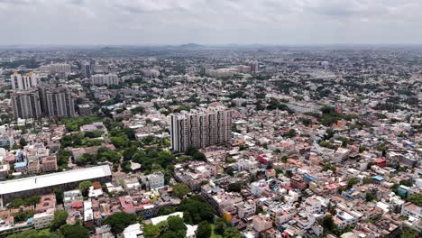 Aerial-shot-of-tall-apartments-in-between-a-crowded-city-during-daytime-in-Chennai,-India