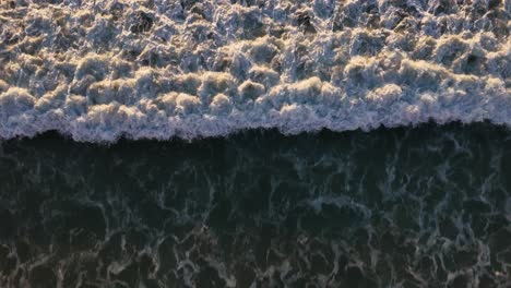 Von-Oben-Nach-Unten-Aufnahme-Einer-Welle,-Die-An-Der-Küste-Zusammenbricht,-Blacks-Beach-San-Diego