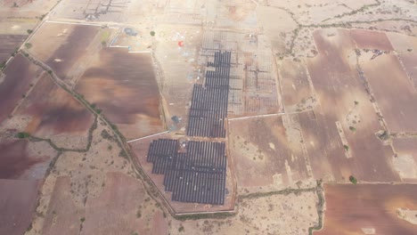 Aerial-drone-view-drone-top-angle-view-showing-many-solar-panels-and-large-wires-of-solar-panels