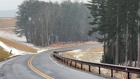 Gentle,-beautiful-snowfall-at-the-beginning-of-of-a-big-nor’easter-on-a-road-in-the-Catskill-mountains-–-slow-motion