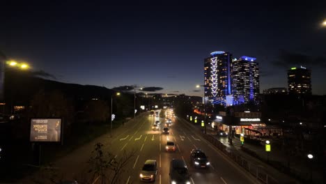 car-traffic-at-'Bulgaria-Boulevard'-at-night,-McDonald's-restaurant,-and-high-rise-buildings-on-the-right