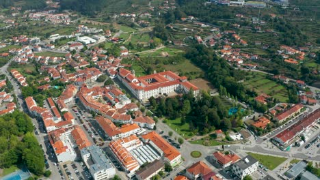 An-aerial-view-capturing-'Santa-Mafalda-de-Arouca-Monastery'-and-the-surrounding-town-in-Aveiro,-a-district-in-Portugal,-taken-with-a-drone