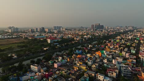Forward-drone-shot-of-a-city-of-Chennai-with-a-lake-during-sunset-in-India