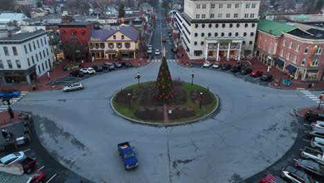 Rising-drone-shot-showing-small-american-city-with-roundabout-in-USA