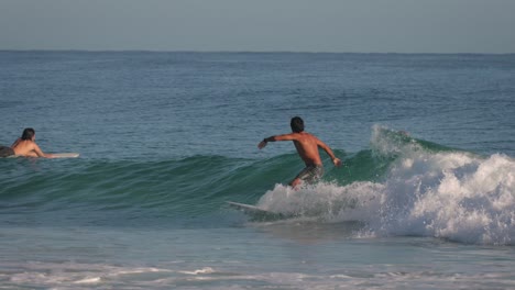 Close-shot-of-a-surfer-enjoying-small-clean-waves-on-a-calm-day-at-Snapper-Rocks,-Gold-Coast