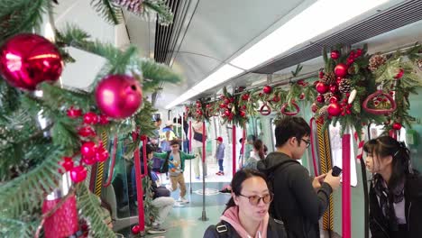 Visitors-inside-retired-train-cars-at-Victoria-Harbour-adorned-with-Christmas-decorations