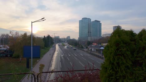 car-traffic-at-'Bulgaria-Boulevard'-at-sunset,-McDonald's-restaurant,-and-high-rise-buildings-on-the-right