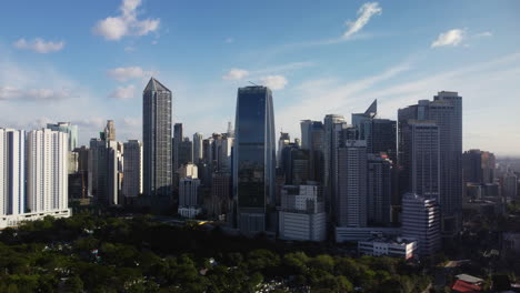 Aerial-view-around-the-Makati-city-skyline,-sunny-day-in-Manila,-Philippines