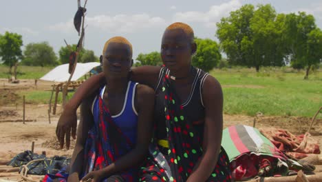 4K-footage-of-two-beautiful-Mundari-women-in-the-cattle-farm-in-terekeka-smiling-to-the-camera