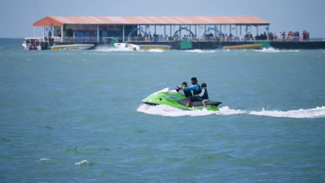 A-father-having-fun-with-his-children-on-board-a-jetski-at-a-beachfront-of-a-popular-tourist-destination-in-Chonburi-province-in-Thailand