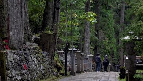 Okunoin-Cemetery-in-Koyasan,-Japan,-tourists-embark-on-a-journey-of-cultural-exploration-amidst-the-serene-and-historic-burial-grounds