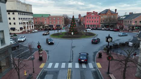 Aerial-approaching-shot-of-roundabout-with-decorated-Christmas-tree-in-american-town