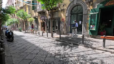 POV-shot-of-walking-a-narrow-street-with-graphite-in-the-city-center-of-Naples-in-Italy
