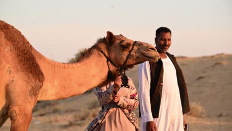 On-January-25,-2024,-A-Bedouin-family-with-their-camels-in-the-Arabian-desert,-a-captivating-portrayal-that-echoes-Arab-history,-life-with-camels
