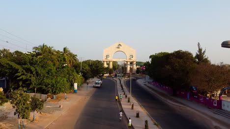 Very-slow-descending-view-of-arch-22-at-Banjul-entrance-next-to-the-highway