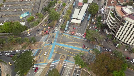 Beautiful-Descending-Top-View-Timelapse-of-Car-Traffic-at-Busy-Intersection-With-MIO-Station