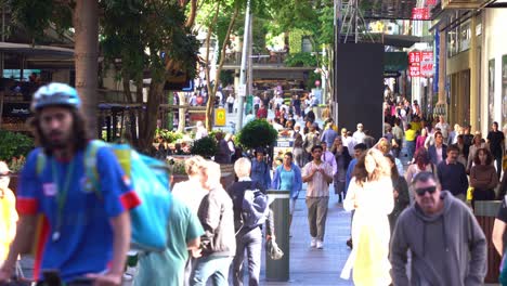 Close-up-shot-of-large-crowd-of-people-shopping-and-dinning-at-Queen-street-mall,-outdoor-pedestrian-shopping-mall-at-downtown-Brisbane-city,-Queensland,-inflation-and-interest-rate-hike