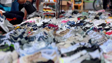 People-choose-second-hand-shoes-at-thrift-store-flea-market