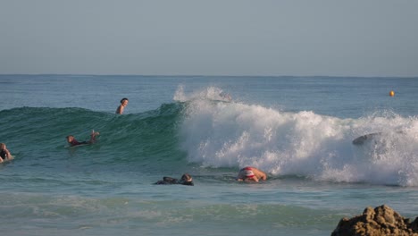 Busy-day-surfing-on-a-calm-sunny-day-at-Snapper-Rocks,-Gold-Coast