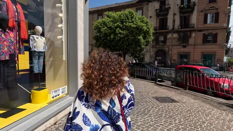 Slow-motion-shot-of-fashion-women-walking-near-a-clothes-shop-in-Naples-Italy