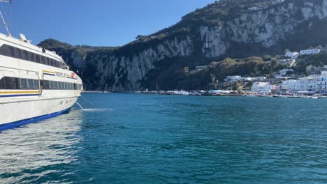 Ferry-arriving-to-large-marina-port-in-Capri-Italian-island-in-sunny-day