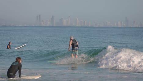 Close-shot-of-a-surfer-on-a-longboard-enjoying-small-clean-waves-on-a-calm-day-at-Snapper-Rocks,-Gold-Coast