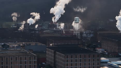 Buffalo-Trace-Bourbon-Distillery-in-Frankfort-kentucky-during-sunset-in-the-winter-with-large-plumes-of-smoke-over-the-rick-houses-AERIAL-ORBIT