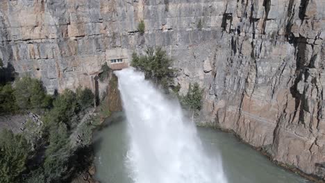 Powerful-water-jet-splash-from-El-Chorro-drainage-point-of-Arenos-Reservoir,-aerial