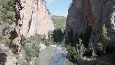 Majestic-rocks-of-river-Mijares-canyon-revealing-forest-valley,-Aragon,-Spain,-aerial