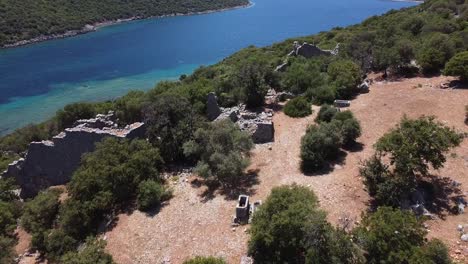 Approaching-aerial-drone-view-over-ancient-Lycian-ruins-on-the-Mediterranean-coast-of-Turkey