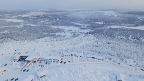 Aerial-tilt-shot-following-a-winter-biking-down-from-the-top-of-the-Iso-Syote-fell,-in-Finland