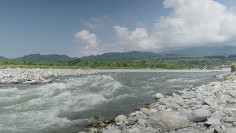 Beautiful-landscape-on-sunny-day,-river-rapids-in-foreground