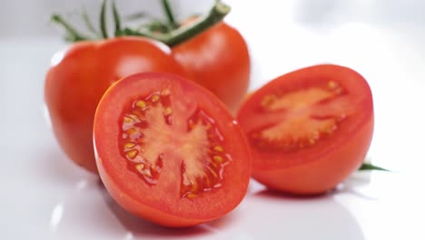 Healthy-food,-Fresh-tomatoes-displayed-on-white-background,-Tracking-out-shot