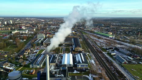 Factory-chimney-smoking-and-polluting-air-in-industrial-city-outskirts