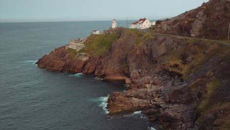Beautiful-aerial-view-of-Fort-Amherst-lighthouse,-coastal-cliffs-and-landscape