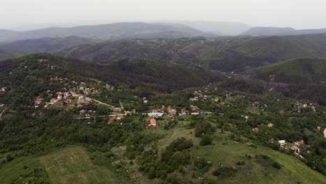 Drone-moving-over-Tsarichina-Village-from-the-left-to-the-right-side-of-the-frame,-showing-the-Strandzha-Mountain-Ranges-in-Bulgaria