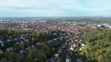 Aerial-drone-shot-of-Heidelberg-and-Handschuhsheim,-flying-above-town-looking-towards-agricultural-and-farming-area
