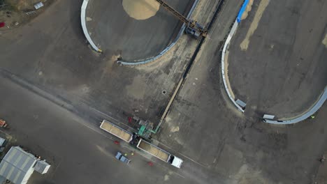 Circular-drone-footage-of-a-grain-truck-being-unloaded-at-huge-silos-in-Western-Australia