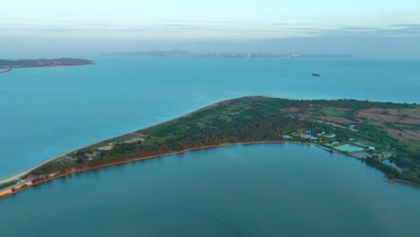 Drone-flight-over-Kinmen-Island,-金門,-Quemoy,-and-Chinese-Coastline-with-Skyline-in-background-at-sunrise-in-Asia