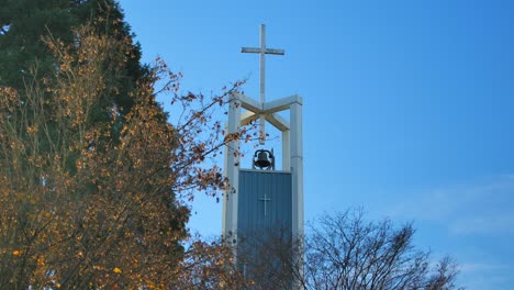 Cross-Atop-Bell-Tower-Of-A-Church-In-Autumn-In-East-Vancouver,-BC,-Canada