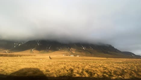 Mountain-range-covered-in-clouds,-seen-from-Hringvegur-road-in-Reykjavíkurborg,-Iceland