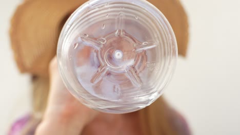 Traveler-woman-drink-water-from-plastic-bottle-in-Tenerife