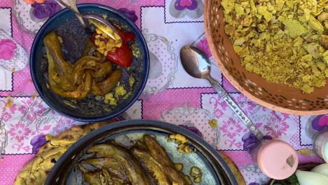 Taste-traditional-food-on-pink-table-cloth-in-Iran-khorasan-rural-countryside-traditional-purple-color-food-made-by-tomato-eggplant-and-qurut-the-kashk-dairy-salty-product-local-people-tourist-love-it