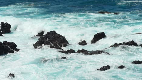 Wave-creates-white-foam-as-it-crashes-on-volcanic-rocks-of-Tenerife